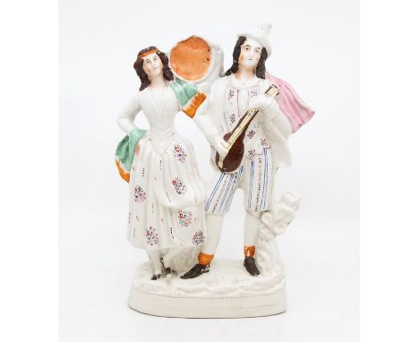 A Staffordshire flatback figure modelled as a Gentleman playing lute and a Lady with tamborine (1) c