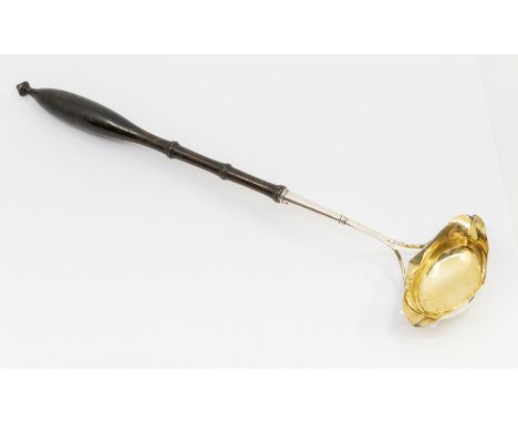 An early 19th Century Swedish silver / parcel gilt boat shaped ladle, turned handle, makers mark probably that of Bengt Tella