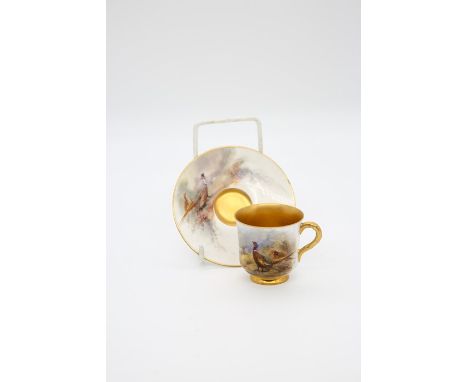 A Royal Worcester small coffee (cabinet) cup and saucer, gilt interior, handle and rim to cup, both painted with a pair of ph