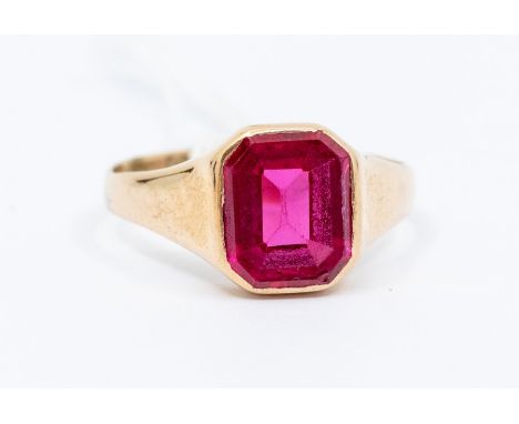 A synthetic ruby and 9ct gold dress ring, comprising an emerald flat top cut synthetic ruby, size approx  7 x 9mm, size S, to