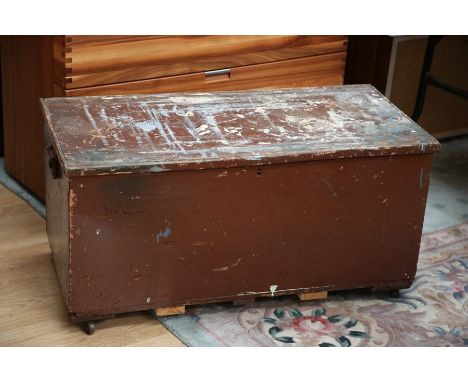 An early 20th Century painted travelling trunk, fitted with a carrying handle to sides, measuring 46cm high, 93cm wide, 46cm 