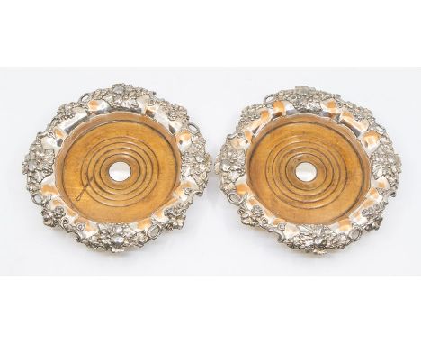 A pair of large old Sheffield plate bottle or decanters coasters, wood base (felt renewed), decorated with vine leaves and gr