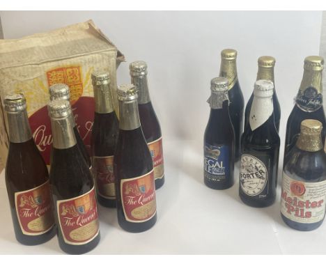 Twelve assorted bottles of beer. Including Guiness, Queens Ale, and more / Please see images for fill level and general condi