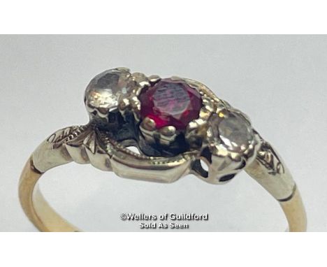 Ruby and white paste three stone twist ring in yellow and white metal stamped 9ct. Estimated weight of ruby 0.18ct. Ring size