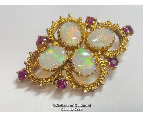 Opal and ruby quatrefoil brooch in 9ct gold. Opals measure approx 9mm x 7mm. Hallmarks for Sheffield 1975 maker HBJ. Weight 8