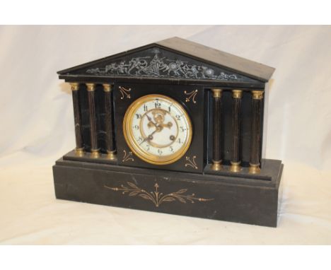 A Victorian mantel clock with  part visible escapement in polished black slate pavilion-style case