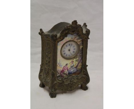 A French mantel clock with decorated circular dial within porcelain panel depicting a woodland clearing with figures in brass