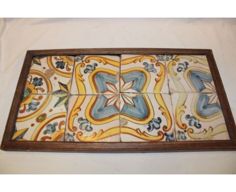 A frame containing 8 early ceramic tiles, 5½" x 5½"