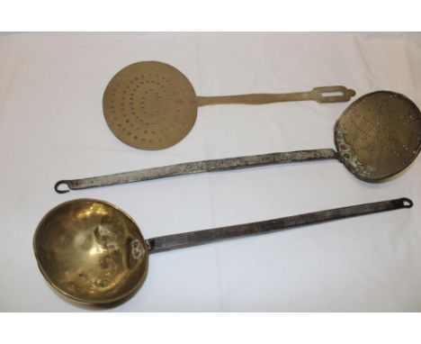 A 19th century brass ladle with iron handle and two various brass mounted milk skimmers (3)