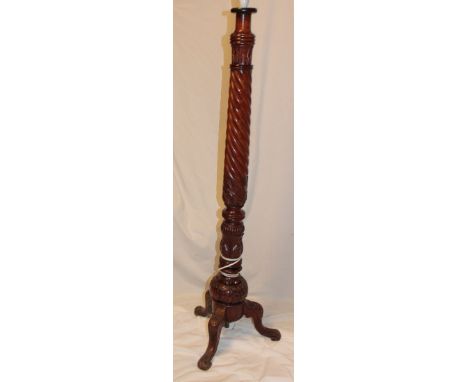 A good quality carved mahogany standard lamp with spiral turned column and carved tripod base