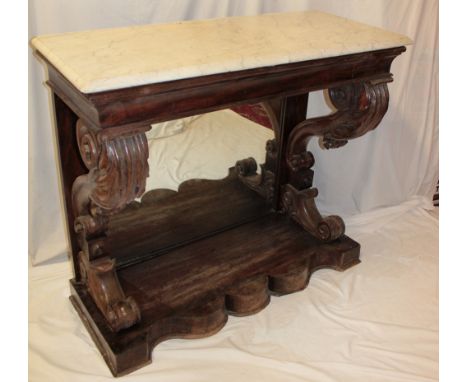 A 19th century mahogany console table with white marble slab top on scroll-shaped legs and plateau base with mirror panelled 