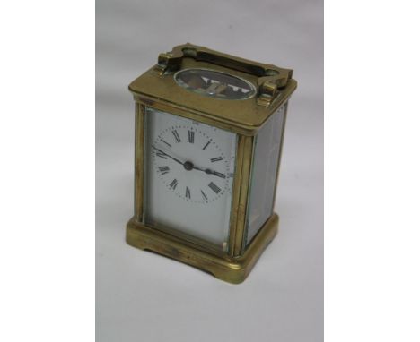 A French carriage clock with enamelled rectangular dial in brass traditional glazed case