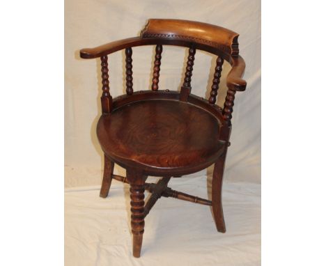 An old beech and elm Captain's-style armchair with bobbin turned back and shaped circular seat with turned legs