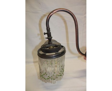 A 1920's oxidized metal wall mounted gas lamp fitment, converted to electric with glass tassled shade