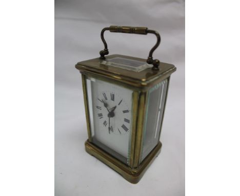 A French carriage clock with enamelled rectangular dial in brass traditional glazed case