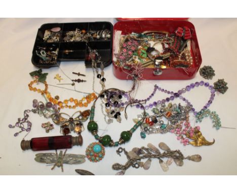 A large selection of various costume jewellery including necklaces, brooches, dress rings, ruby tinted glass double-ended sce