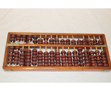 An Eastern brass mounted table abacus, 17½" long