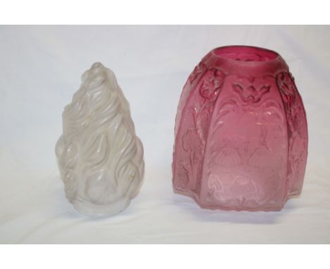 A Victorian cranberry tinted glass oil lamp shade with etched and raised floral decoration, 8" high and one other torch-style