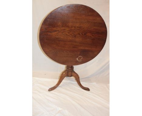A 19th century oak circular snap-top occasional table with turned column and tripod base
