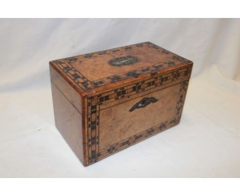 A Victorian inlaid walnut rectangular tea caddy with internal mahogany covers enclosed by a hinged lid, 9" long