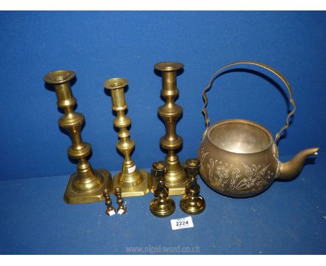 A quantity of brassware to include various candlesticks and a large teapot (lid missing).