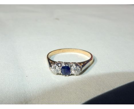 A 9ct gold lady's ring set with a small central sapphire and a pair of small diamonds (3 medium approx.), size L