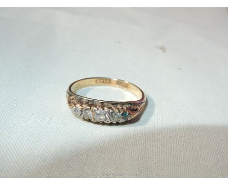 An 18ct gold ring set with 5 small diamonds (do not test as diamonds), very small, less than K