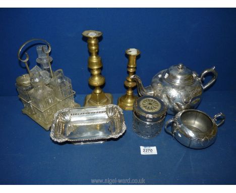 A small quantity of plated items to include; teapot, sucrier, condiments on stand, bonbon dish, etc, plus two odd brass candl