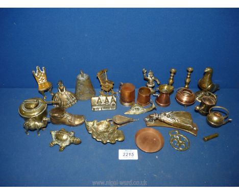 A quantity of brass miniatures including bells, rocking chair, door, knocker, old boot, snail, brass wick for an oil lamp, et