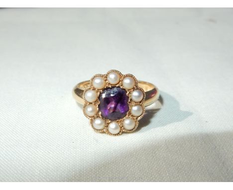 A lady's 18ct gold ring set with a central oval amethyst surrounded by 10 seed pearls, size O