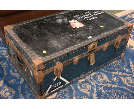 Antique metal bound wooden steamer trunk with feminine fabric lined interior marked to top Miss L.A Bell