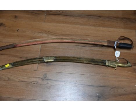 Two vintage swords in sheaths  This bladed lot is not for sale to people under the age of 18. By bidding on this item you are