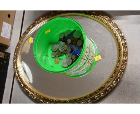 Oval mirror and tub of vintage coins 