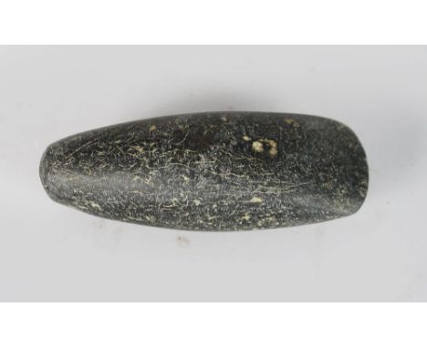 A NEOTHLITHIC AXE HEAD. 4ins long.