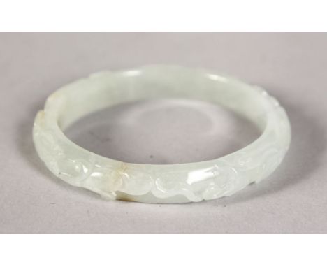 A CARVED WHITE JADE BANGLE.