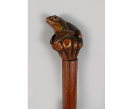 A FOLK ART WALKING STICK with carved frog handle.