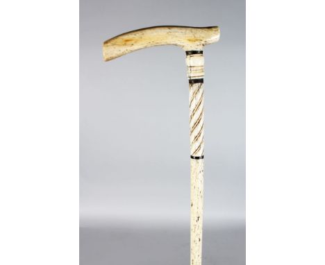 A 19TH CENTURY MARINE IVORY-HANDLED WALKING STICK with turned plain and twisted  upper section, on a slender turned shaft. 