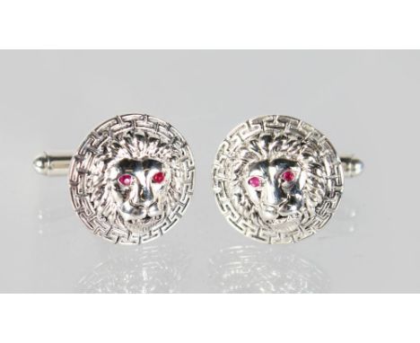 A GOOD PAIR OF SILVER "LION'S HEAD" CUFFLINKS with ruby eyes.