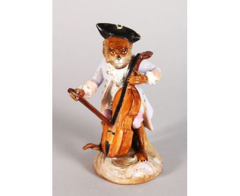 A CONTINENTAL PORCELAIN MONKEY FIGURE PLAYING A CELLO. 5in high.