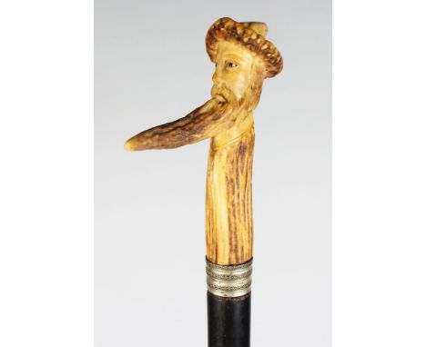 AN UNUSUAL CARVED HORN WALKING STICK, the handle as a man's head with very long beard. Handle: 4ins long.