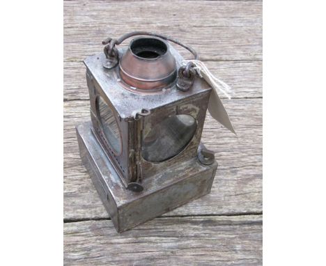 A railway signal lamp interior with reservoir and brass burner stamped "HADDISCO" 