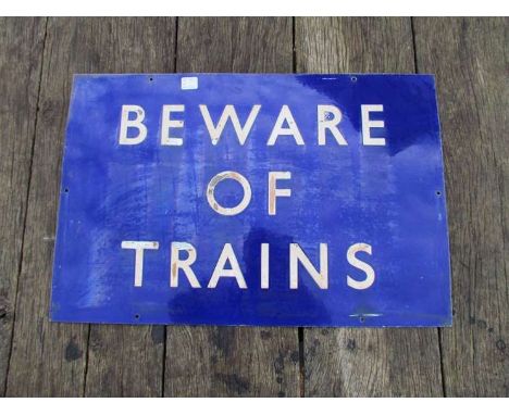 An enamel railway sign "BEWARE OF TRAINS"