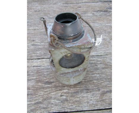 A railway signal lamp interior with reservoir and burner (lid missing)