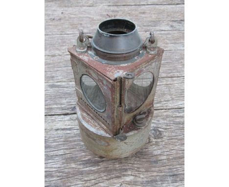 A railway signal lamp interior with circular reservoir and brass burner 