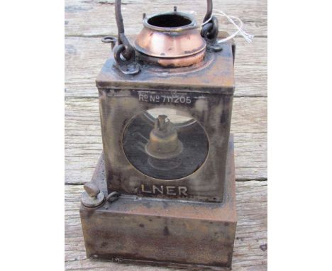 A railway signal lamp interior with reservoir and brass burner
