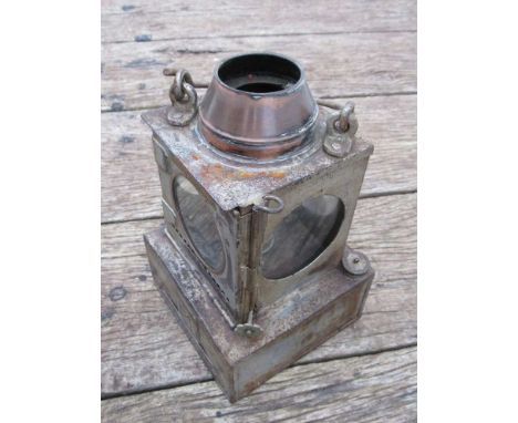 A railway signal lamp interior with reservoir and ceramic burner, stamped 'SAXMUNDHAM'