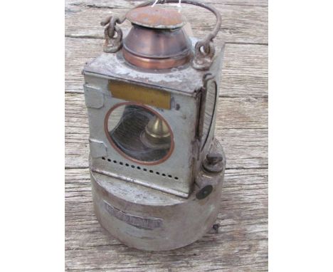 A railway signal lamp interior with circular reservoir and brass burner, stamped "NORWICH THORPE"