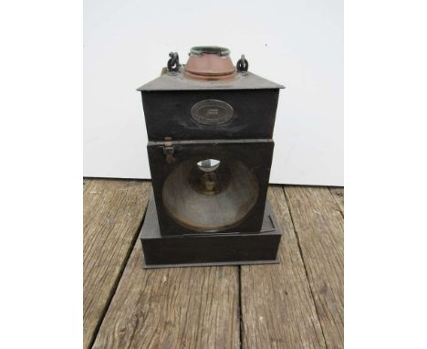 A large railway signal box lamp with glass chimney and burner, stamped B.R (E)