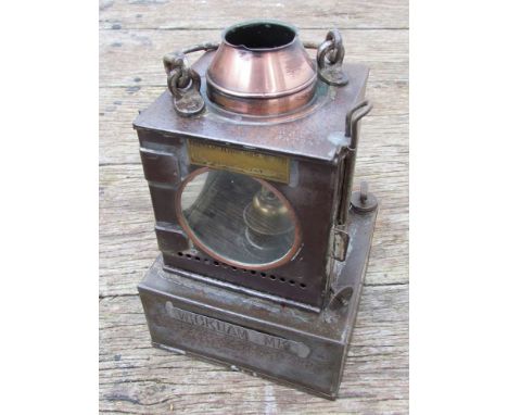 A railway signal lamp interior with reservoir and brass burner, stamped "WICKHAM MARKET"