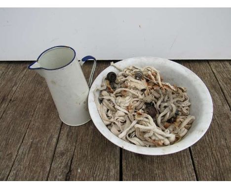 An enamelled water jug and wash bowl and a large quantity of oil lamp wicks 